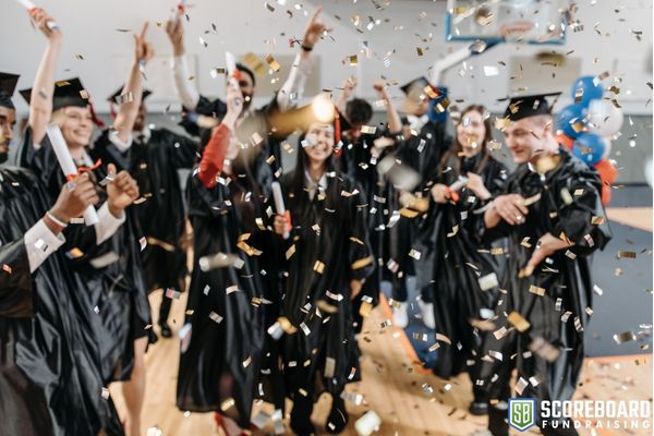 Graduating seniors celebrating, confetti falling.