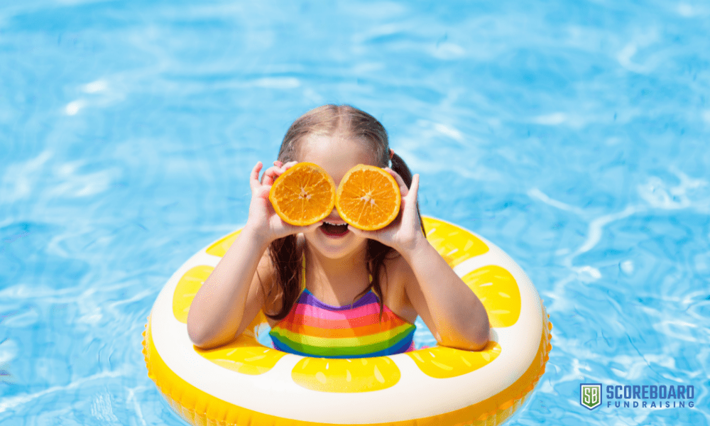 1 Girl in swimming pool with oranges.