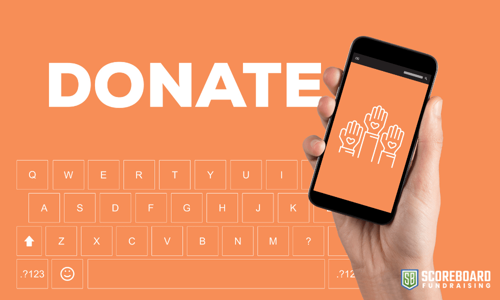 1 The word donate with a hand holding a cell phone.